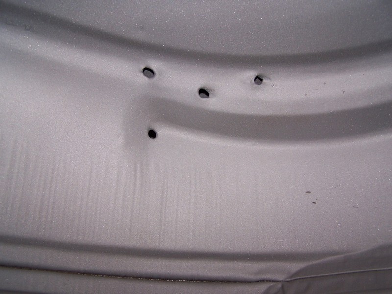 Curious holes in outer wheel house.