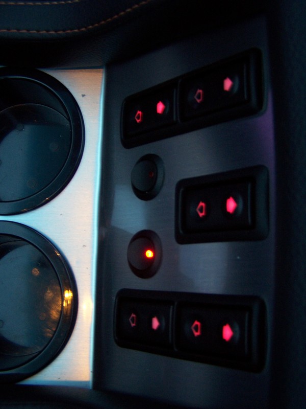 Window controls... The convertible is the center switch, two small round, are driving lights and center brake light in light bar, off when top is up.